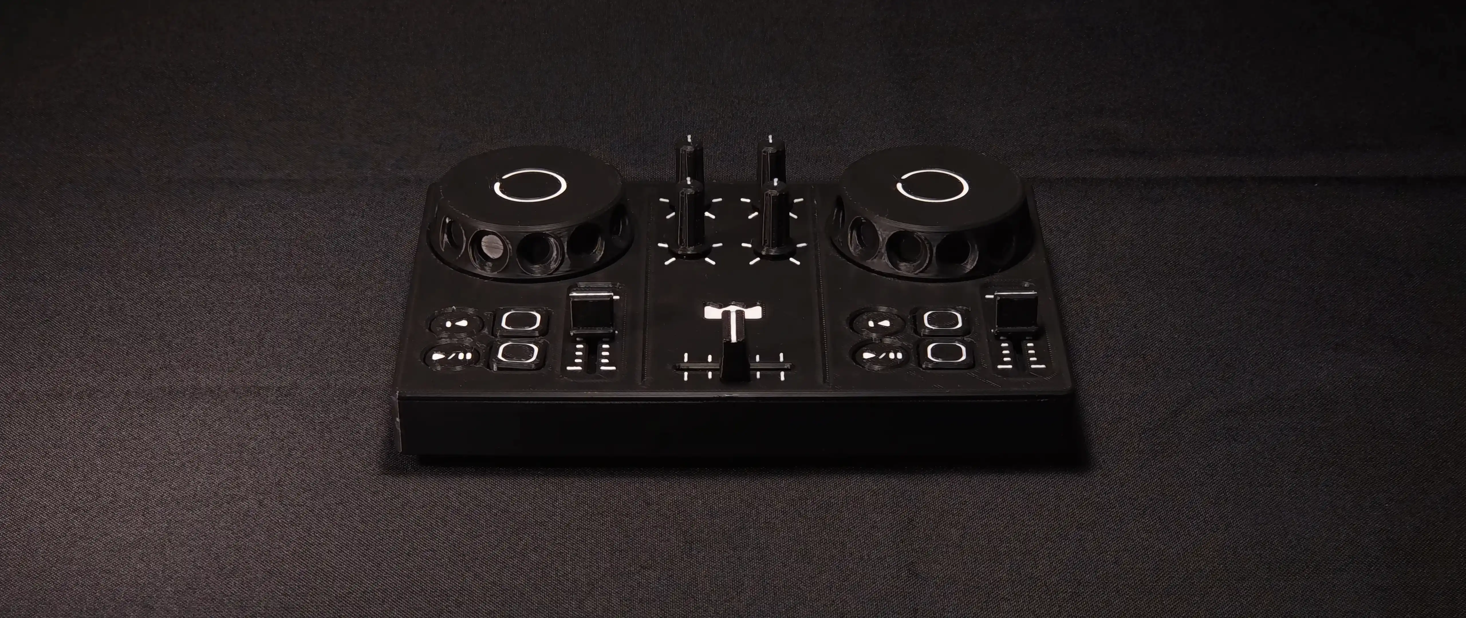 DJC-DIY, printed in black, standing on dark cloth and lit from above