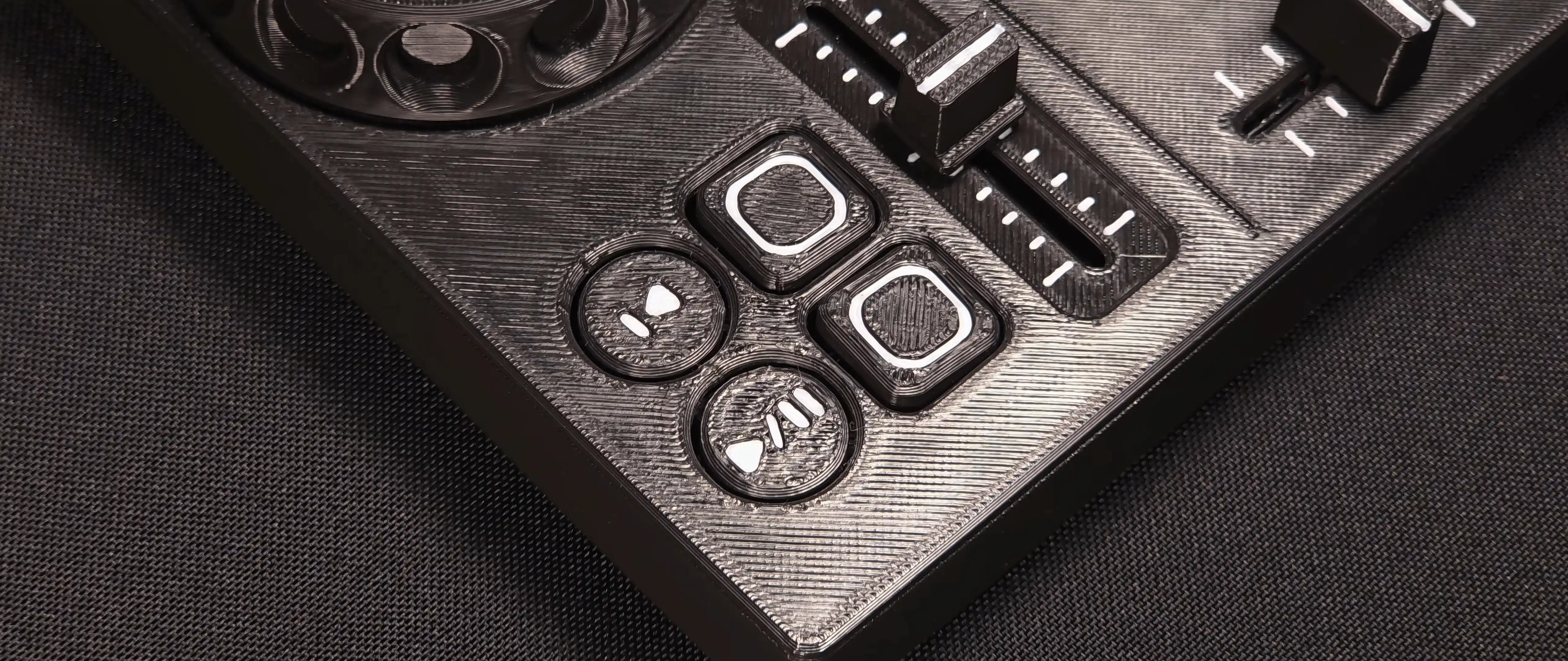 Close-up of the play, cue and performance pad buttons on one deck, with the tempo fader behind them