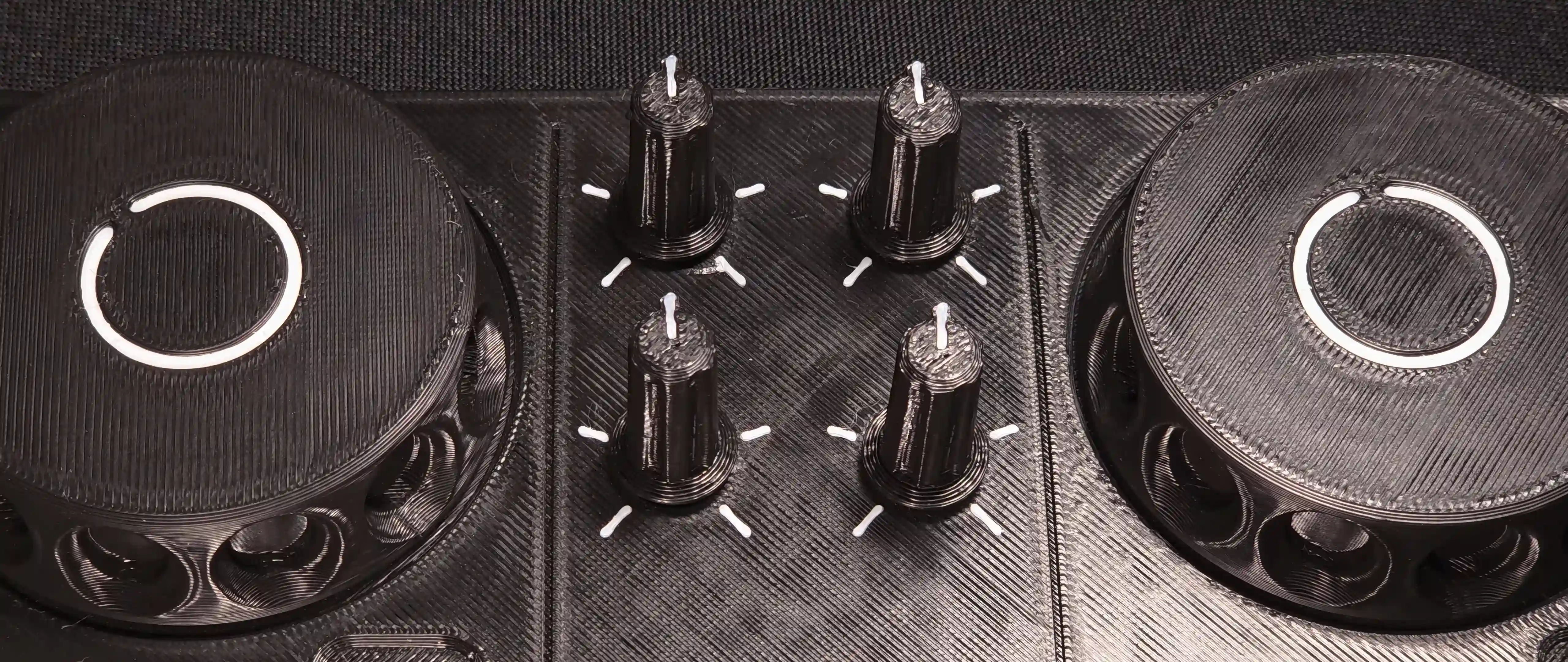 Close-up of the four knobs between the two jog wheels