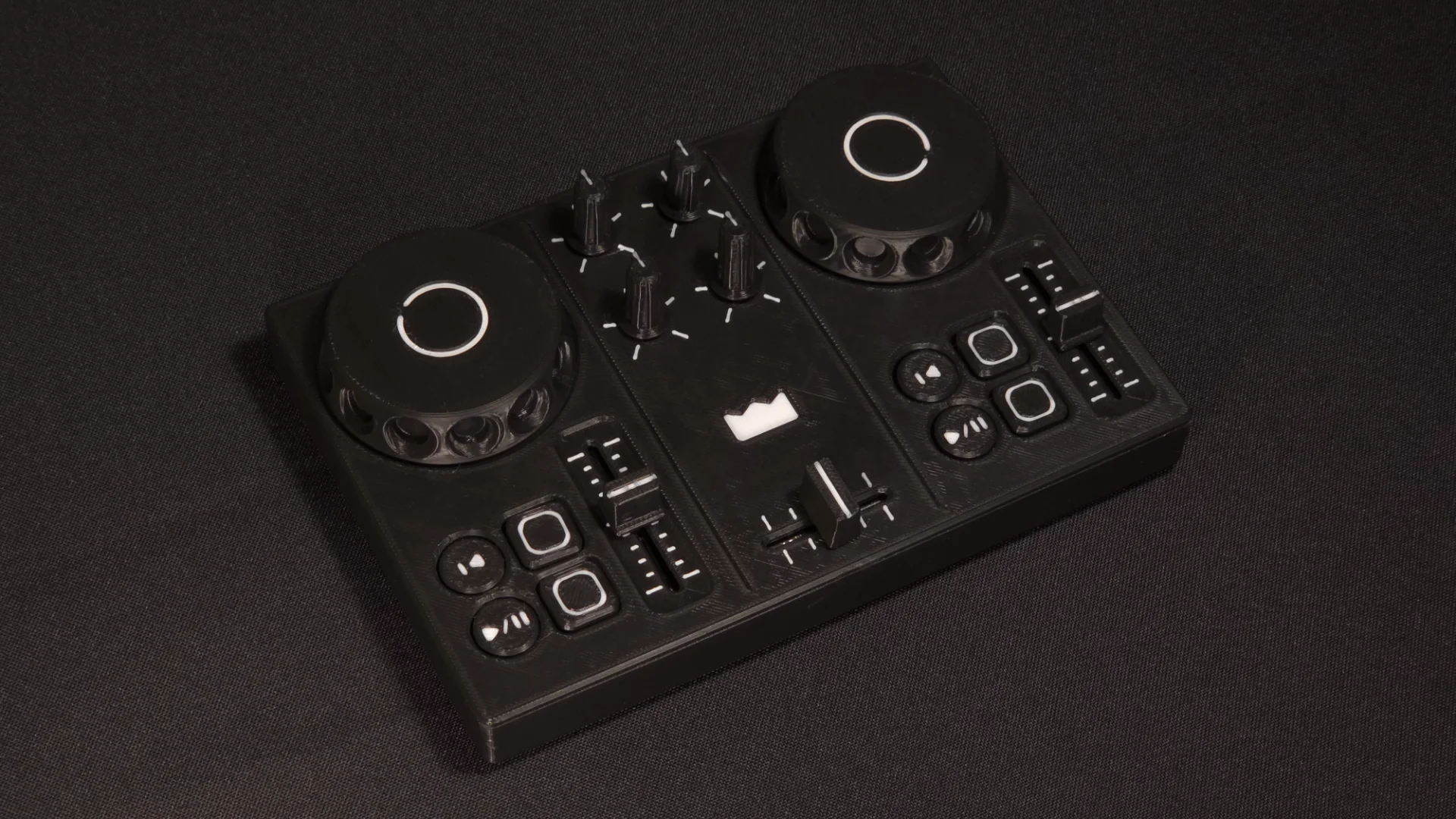 DJC-DIY, a DIY DJ controller, printed in black and photographed from above on dark cloth