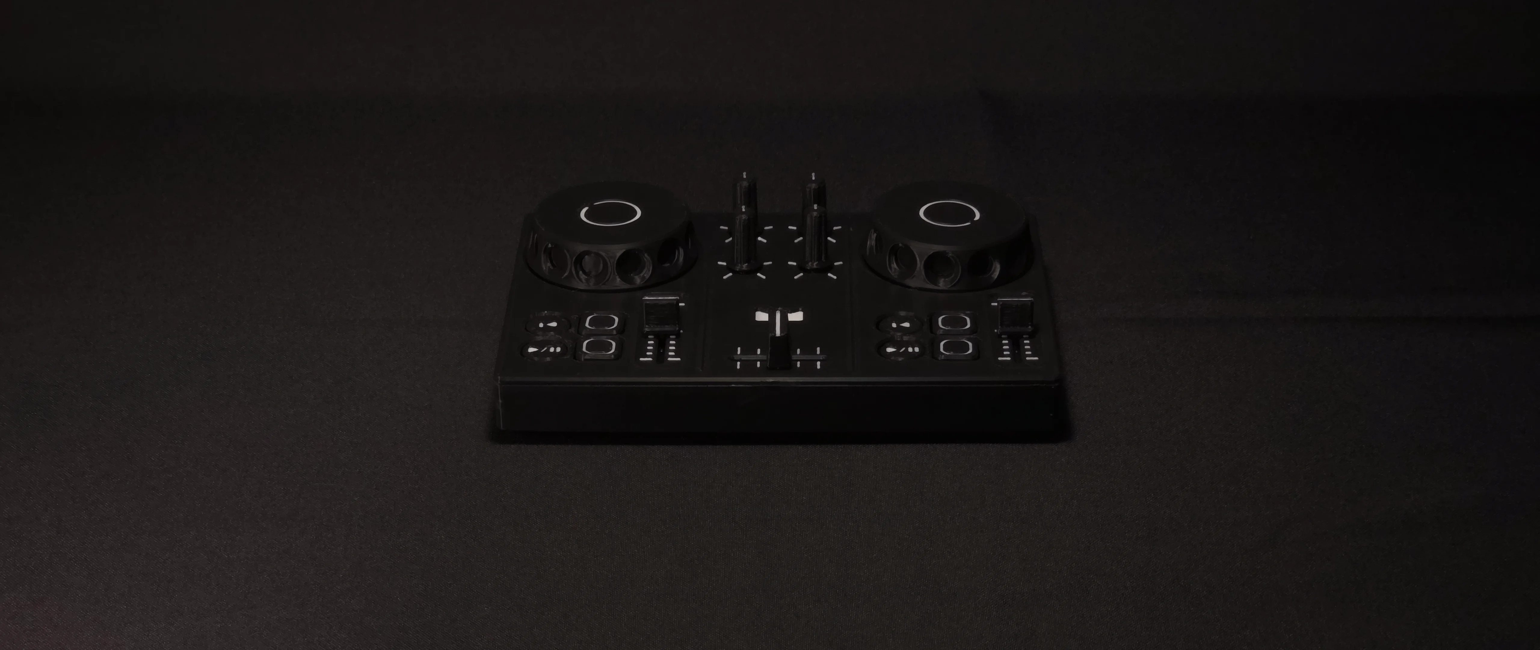 DJC-DIY, printed in black, standing alone on dark cloth in dim light